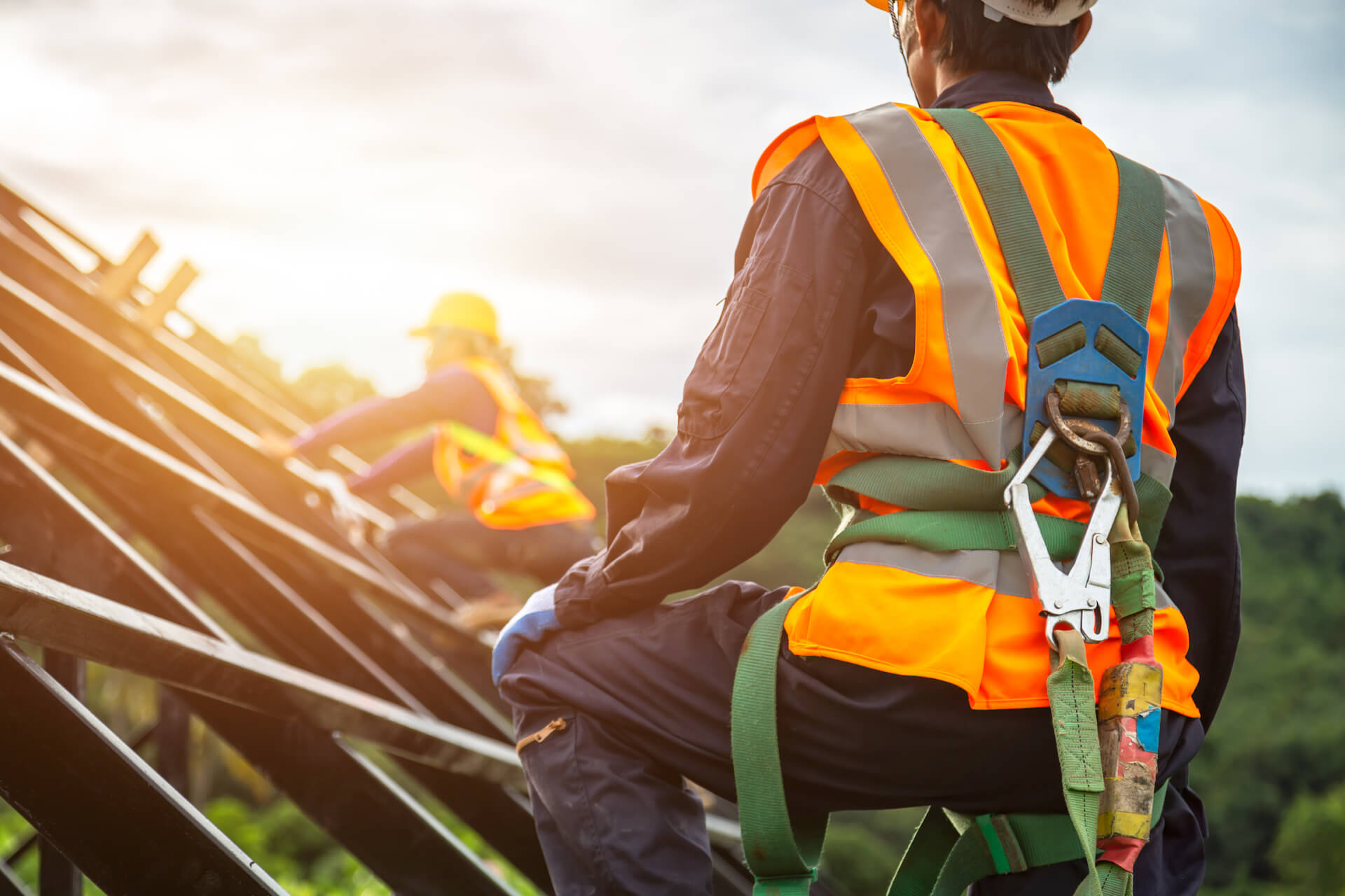 Worker wearing a safety harness with hooks