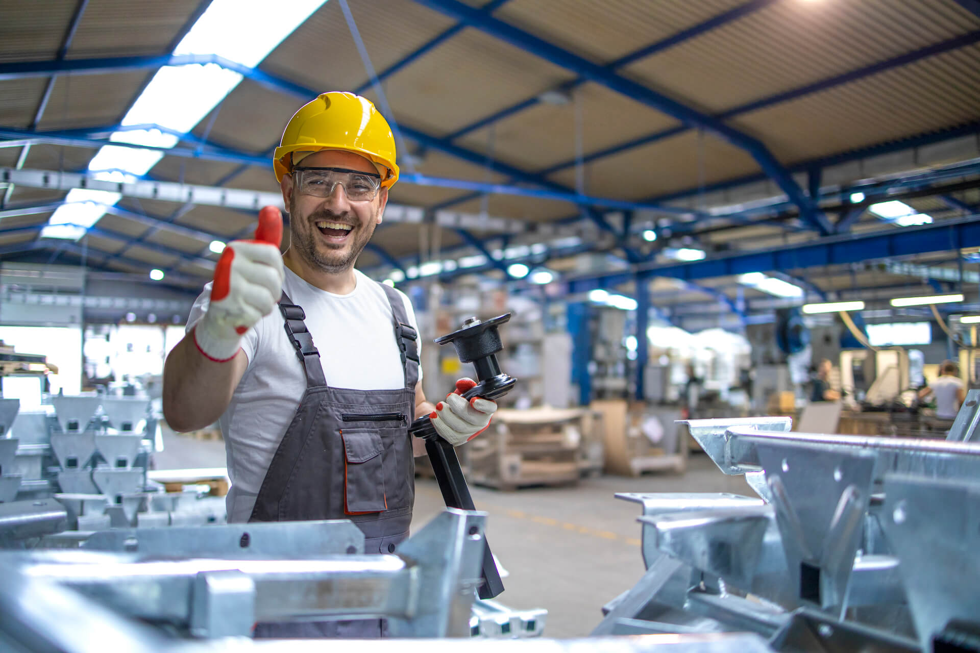 Factory worker in protective equipment giving a thumbs up